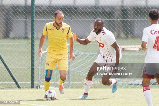 S Fatih Kaya and Standard's Merveille Bope Bokadi fight for the ball during a friendly soccer match between Belgian Jupiler Pro League team Standard...