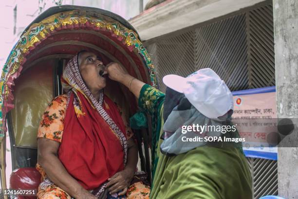 Woman receives an oral cholera vaccine from a health worker during the vaccination campaign. The government is set to start administering an oral...