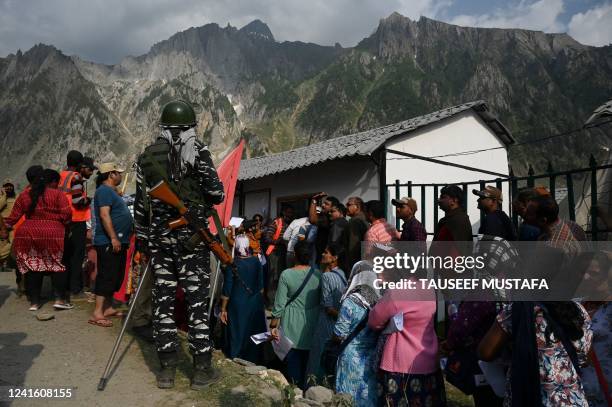 Hindu pilgrims are in a queue as government officials checks papers at Baltal Base Camp, where Hindu pilgrims spend the night before proceeding to...
