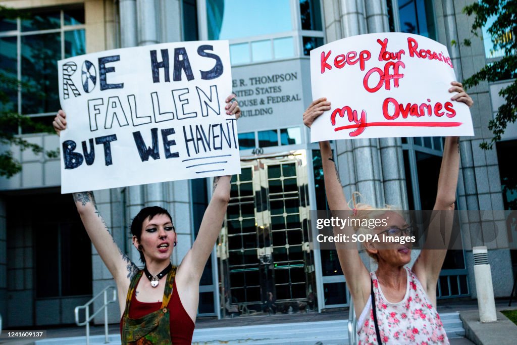 Protestors hold placards expressing their opinion during a protest ...