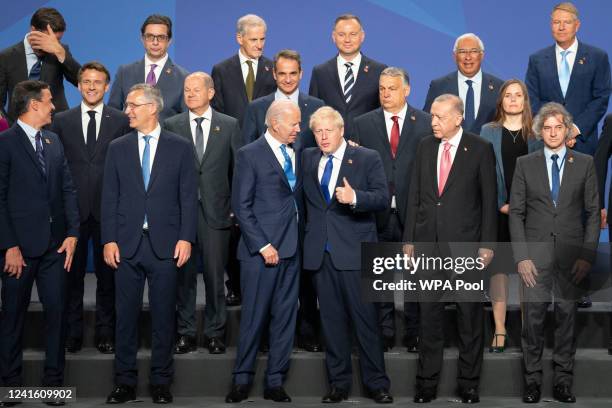 British Prime Minister Boris Johnson stands beside US President Joe Biden and other world leaders posing for a family photo during the Nato summit on...