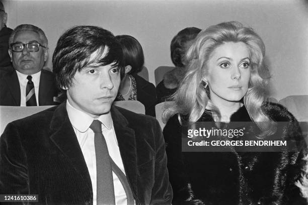 French actress Catherine Deneuve and her husband British photographer David Bailey attend the premiere of the film "Le Scandale" directed by Claude...
