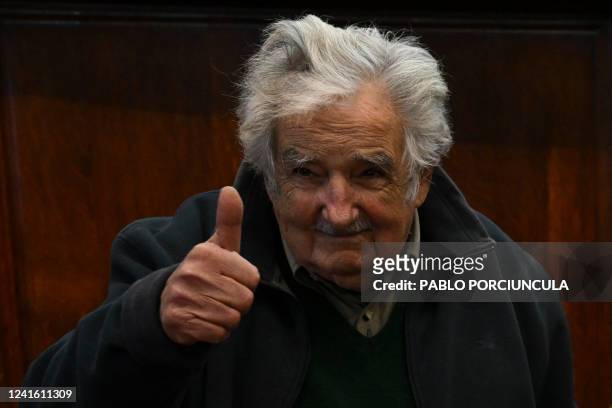 Uruguayan former President Jose Mujica gives a thumbs up during the ceremony in which he received the degree of Doctor Honoris Causa by Argentina's...
