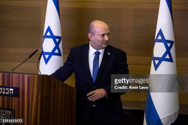 Israeli Prime Minister Naftali Bennet leaves after giving a statement to the press he will not take part in the coming general elections on June 29,...