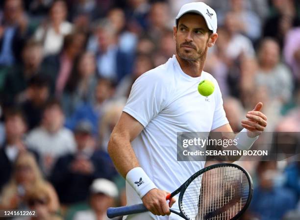 Britain's Andy Murray reacts during his men's singles tennis match against US player John Isner on the third day of the 2022 Wimbledon Championships...