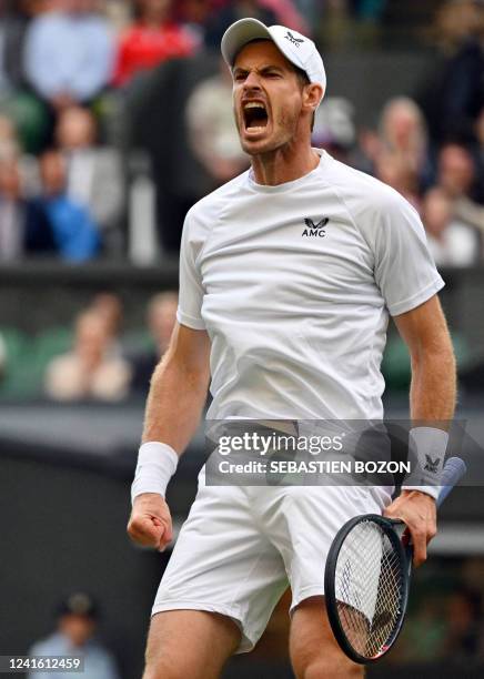 Britain's Andy Murray reacts as he competes against US player John Isner during their men's singles tennis match on the third day of the 2022...