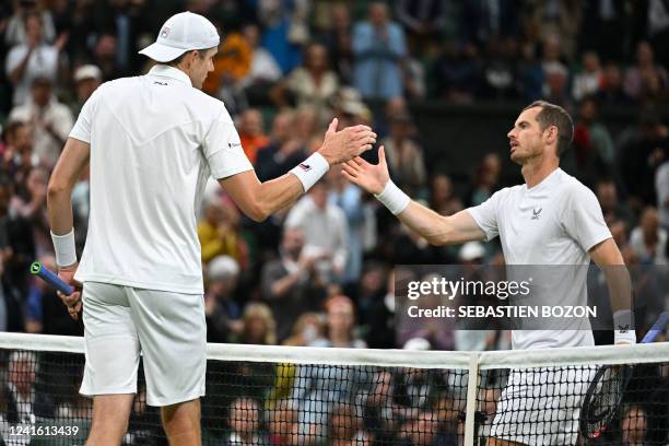 Britain's Andy Murray shakes hands with US player John Isner after their men's singles tennis match on the third day of the 2022 Wimbledon...