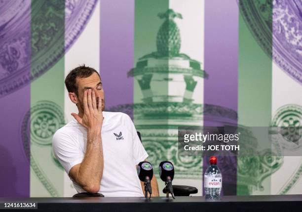 Britain's Andy Murray reacts as he speaks to the media in the Main Interview Room following his defeat to US player John Isner during their men's...