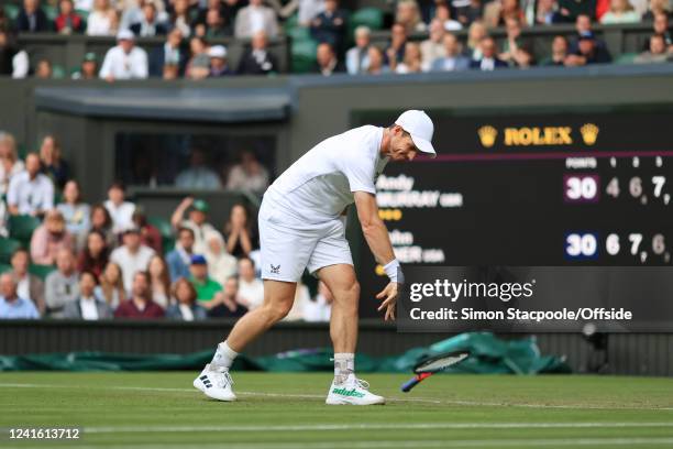 Andy Murray throws his racket down in anger during his Gentlemen's Singles 2nd Round match against John Isner during day three of The Championships...