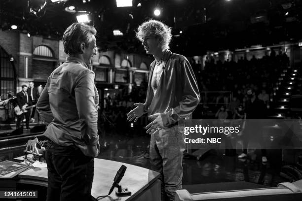 Episode 1315 -- Pictured: Host Seth Meyers talks with Machine Gun Kelly during a commercial break on June 29, 2022 --