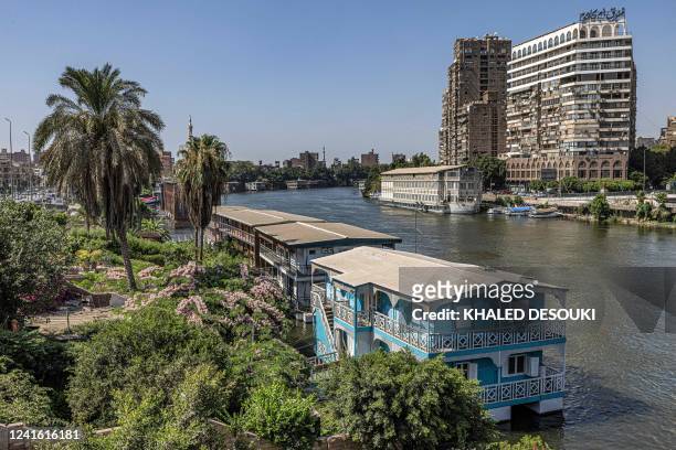 This picture taken on June 27, 2022 from the Giza side of the Nile river shows houseboats moored along the Giza bank in the Agouza district off the...