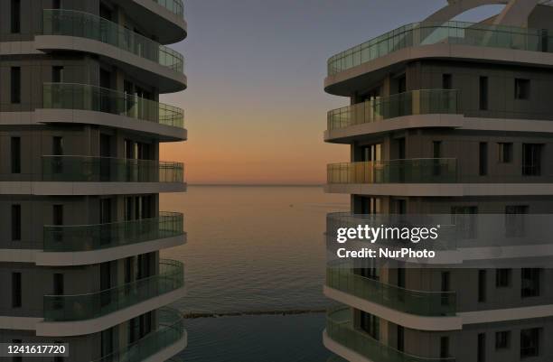 View of the sea through the high-rise luxury residential complex &quot;Limassol Del Mar&quot; early in the morning in the Mediterranean port of...
