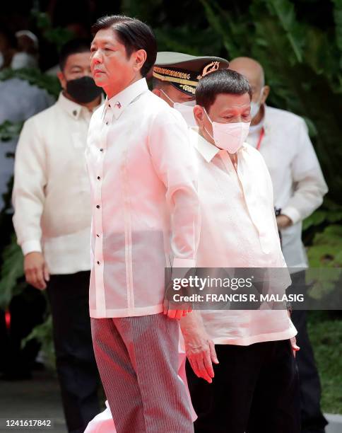 Incoming Philippine President Ferdinand Marcos Jr and outgoing President Rodrigo Duterte take part in the inauguration ceremony for Marcos at the...