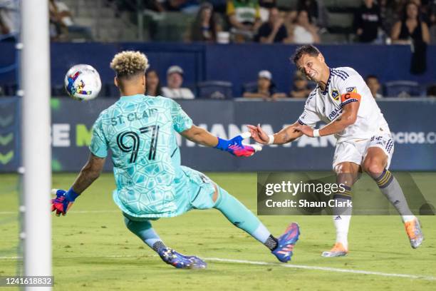 Javier Hernández of Los Angeles Galaxy shoots the ball against Dayne St. Clair of Minnesota United during the game at Dignity Health Sports Park on...