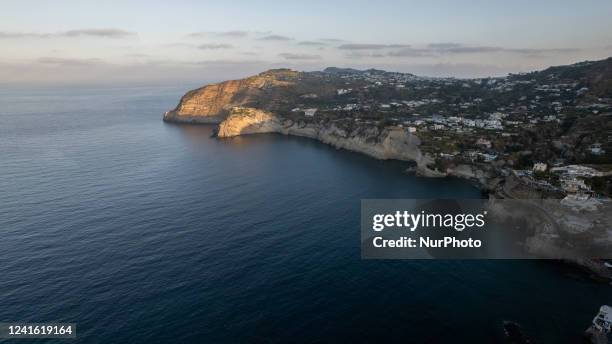 Drone view of the Tyrrhenian Sea coastline at sunrise, in the island of Ischia, Italy, on June 30, 2022.