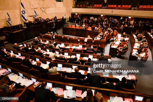 This picture shows a general view of the Israeli Knesset during a meeting, in Jerusalem on June 30, 2022. - Israeli lawmakers dissolved parliament...