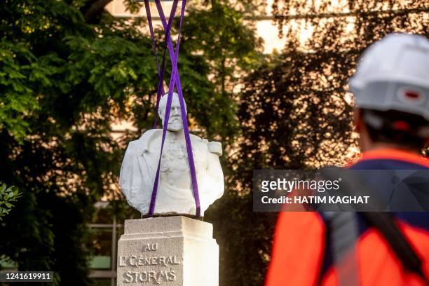 Picture taken on June 30, 2022 in Brussels shows the removal of a bust of General Storms from its original place in the square de Meeus to be placed...