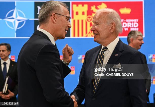 Secretary General Jens Stoltenberg greets US President Joe Biden ahead of a meeting of The North Atlantic Council during the NATO summit at the Ifema...