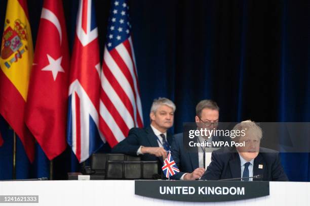 Prime Minister Boris Johnson attends a signing ceremony of the NATO Innovation Fund with other world leaders during the Nato summit in Madrid, on...