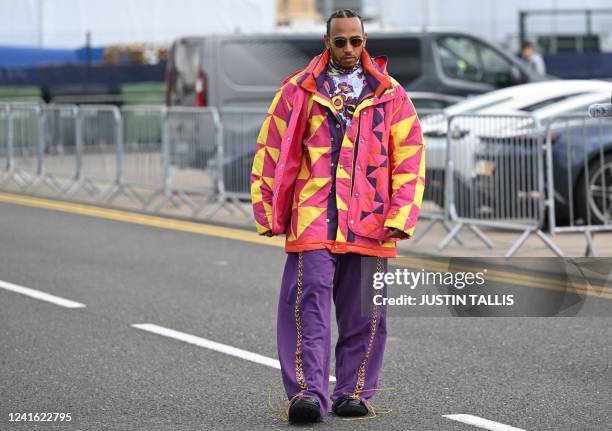 Mercedes' British driver Lewis Hamilton arrives in the paddock ahead of the Formula One British Grand Prix at the Silverstone motor racing circuit in...