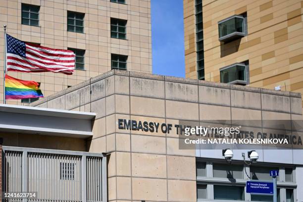National and rainbow flags are pictured on the US embassy in Moscow on June 30, 2022. Moscow officials changed the official address of the US embassy...