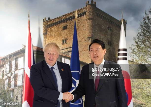 British Prime Minister Boris Johnson greets South Korea's President Yoon Suk-yeol ahead of a bilateral meeting during the NATO summit in Madrid, on...