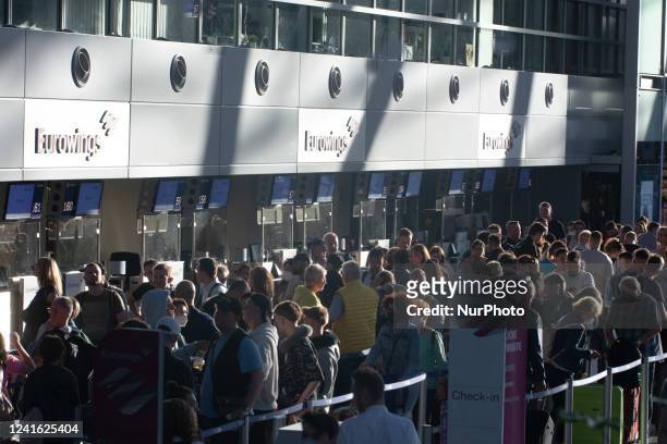 Passengers are seen waiting in front of Eurowings check in counter at Duesseldorf airport in Duesseldorf, Germany on June 30, 2022 as governments...