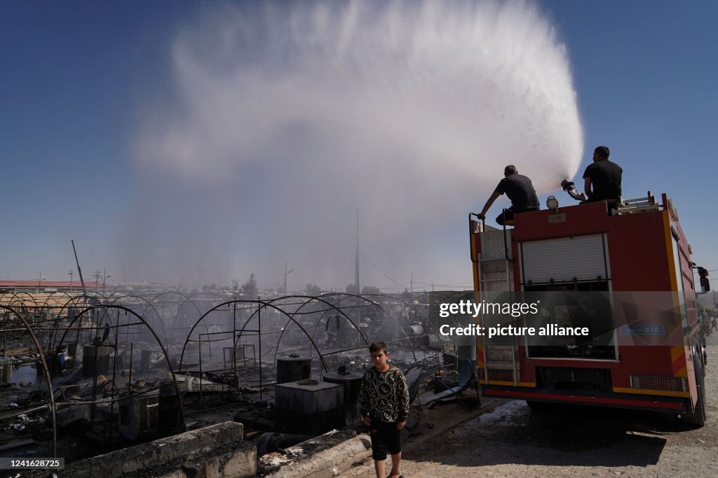Iraq Fire Engine A fire engine douses the remainder of the flames that scorched tents ...