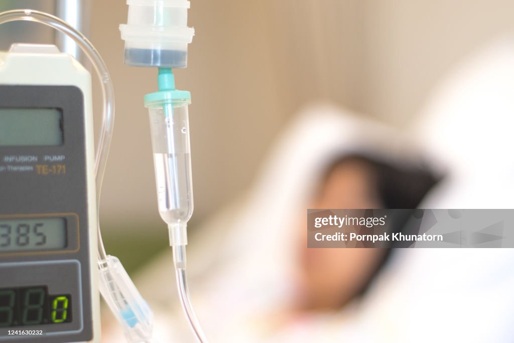 Child patient with IV line in hand sleep on hospital bed. Medical palliation healthcare concept