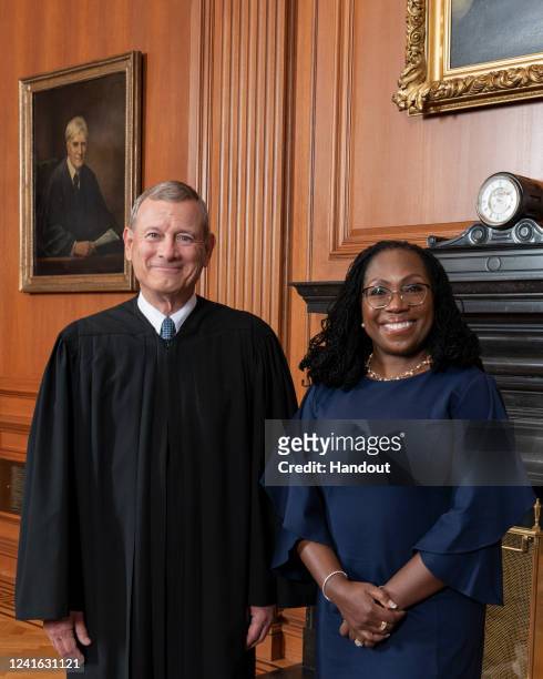 In this handout provided by the Supreme Court, Chief Justice John G. Roberts, Jr. Poses for a portrait with Justice Ketanji Brown Jackson in the...