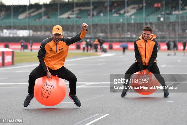 Lando Norris of Great Britain and Mclaren and Daniel Ricciardo of Australia and Mclaren on space hoppers during previews ahead of the F1 Grand Prix...