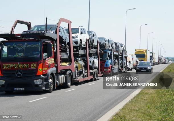 Queues with trucks loaded with cars are seen near the Polish-Ukrainian border near Korczowa on June 30, 2022 due to the return of the import tax on...