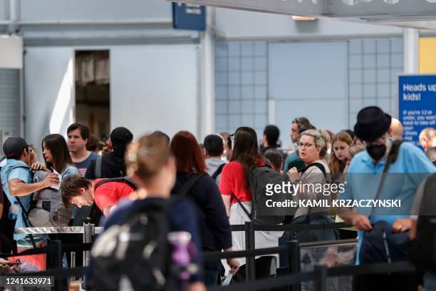 Departing travelers wait in line at O'Hare International Airport on June 30, 2022 in Chicago, Illinois. - Based on projections from airline carriers...