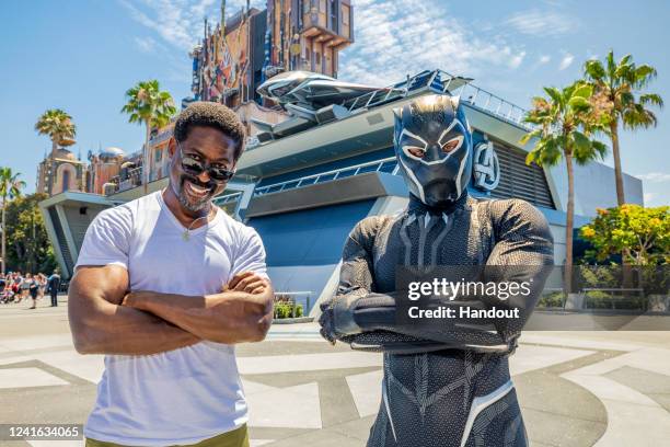 In this handout photo provided by Disney Resorts, actor and producer Sterling K. Brown poses with Black Panther in the Avengers Campus at Disney...