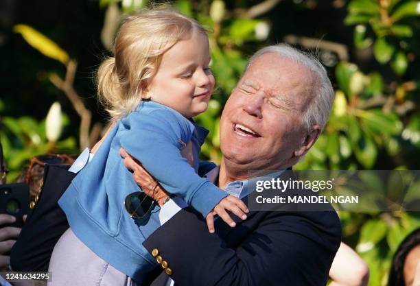 President Joe Biden lifts grandson Beau, the son of Hunter Biden, after Biden returned to Washington, DC on June 30, 2022. Biden returned to...