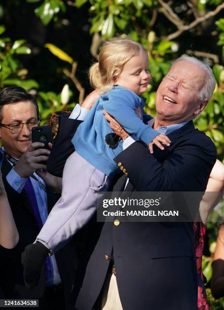 President Joe Biden lifts grandson Beau, the son of Hunter Biden, after Biden returned to Washington, DC on June 30, 2022. Biden returned to...