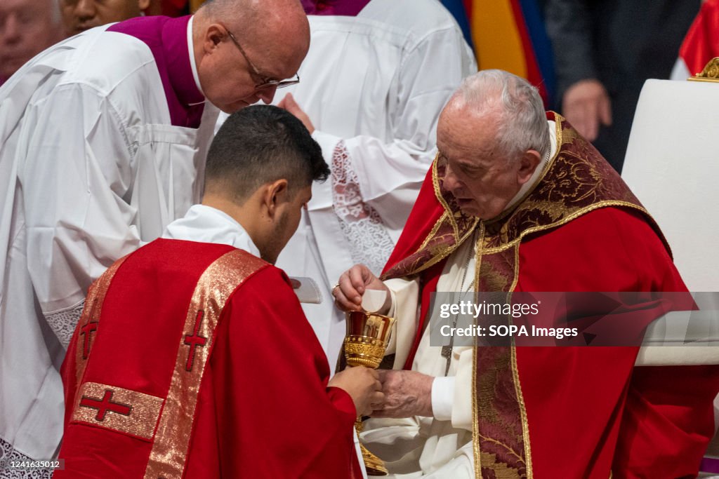 Pope Francis receives holy communion during the Mass as he...