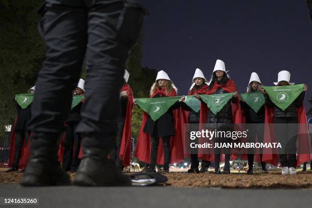 Pro-choice activists disguised as characters from Canadian author Margaret Atwood's feminist dystopian novel "The Handmaid's Tale", display green...