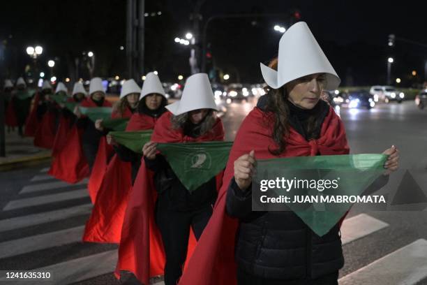 Pro-choice activists disguised as characters from Canadian author Margaret Atwood's feminist dystopian novel "The Handmaid's Tale", display green...