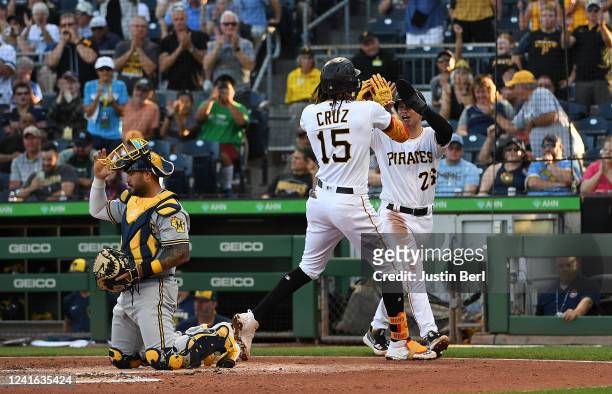 Oneil Cruz of the Pittsburgh Pirates high fives with Josh VanMeter after hitting a two run home run in the second inning during the game against the...