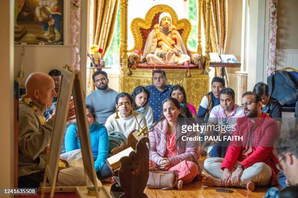 Followers of Hare Krishna listen to a lecture after prayer, on the island of Inish Rath on Lough Erne, near Enniskillen, western Northern Ireland, on...