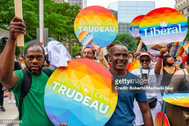 Members of the Team Trudeau march holding signs in Bloor Street during Pride Parade.