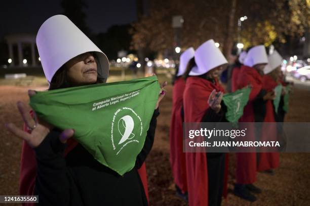 Pro-choice activists disguised as characters from Canadian author Margaret Atwood's feminist dystopian novel "The Handmaid's Tale", display green...