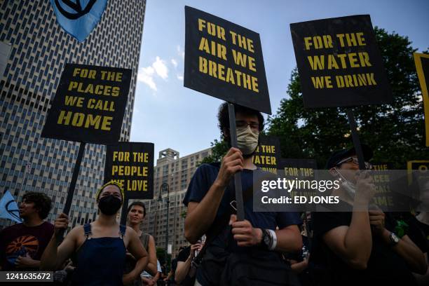 Climate activists attend a protest against a US Supreme Court ruling limiting government powers to curb greenhouse gases, in New York on June 30,...