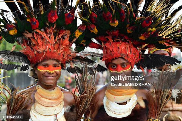 This file picture taken on November 15, 2018 shows Papuan villager clad in traditional costume performing before the arrival of China's President Xi...
