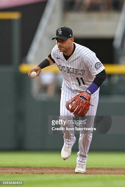 Colorado Rockies shortstop Jose Iglesias throws to first base after fielding a ground ball during a game between the Los Angeles Dodgers and the...