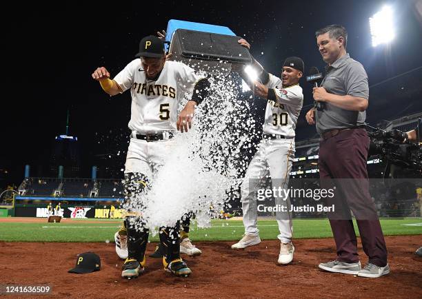 Michael Perez of the Pittsburgh Pirates has ice dumped on him during a postgame interview after hitting three home runs during the game against the...