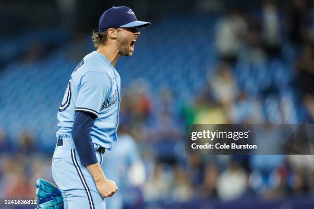Adam Cimber of the Toronto Blue Jays celebrates a win at the end of their MLB game against the Tampa Bay Rays at Rogers Centre on June 30, 2022 in...