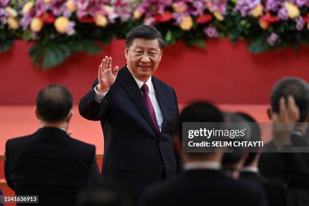 China's President Xi Jinping waves following his speech after a ceremony to inaugurate the city's new leader and government in Hong Kong on July 1 on...