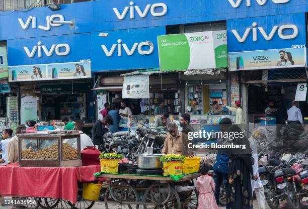 Pedestrians and vendors outside a mobile phone market in Karachi, Pakistan, on Thursday, June 30, 2022. Pakistani government has increased gasoline...